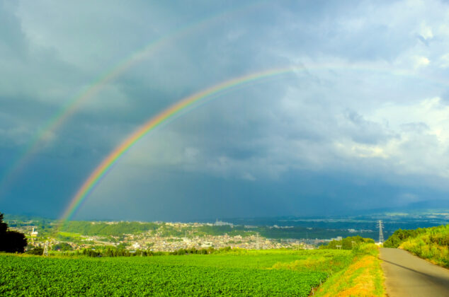 Double rainbow shown over farmland