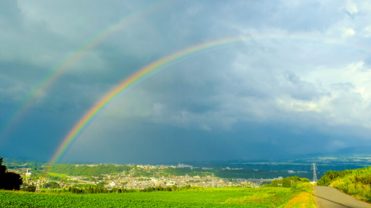 Double rainbow shown over farmland